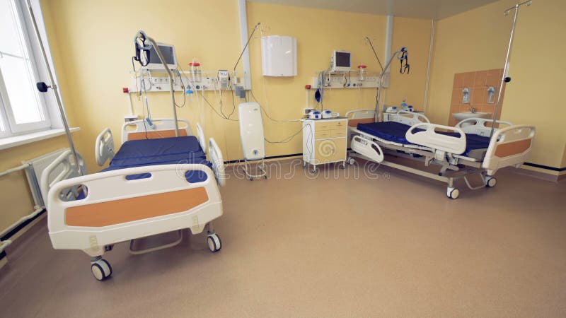 Hospital ward interior with two beds in it.