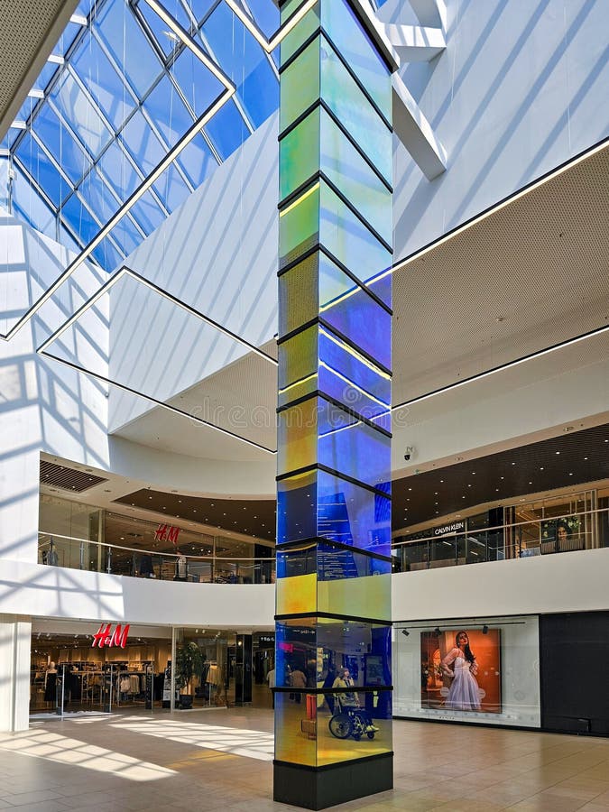 Modern futuristic interior with multi-colored mirror column in Akropole Alfa shopping mall, Riga