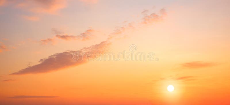 Sunrise sky in the morning with colorful yellow sunlight and cloud on panoramic orange sunset sky background in golden hour time.