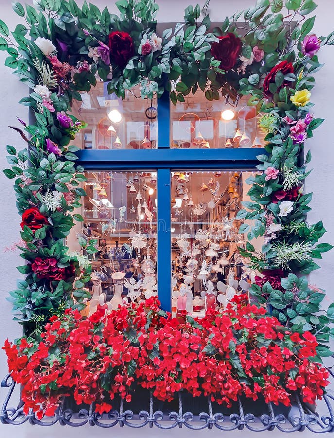 Exterior decorative decoration of a souvenir shop window with floral decor in the Riga Old Town