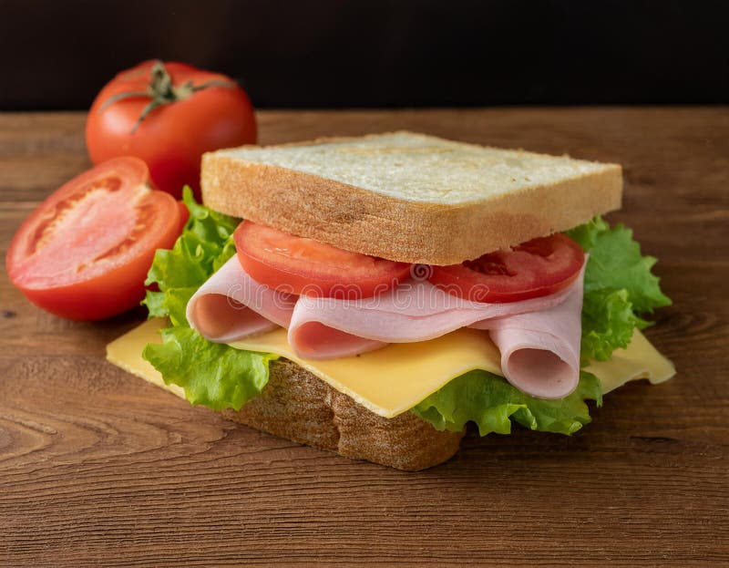 Sandwiches on wooden table. Sandwiches with chicken breast, salad, cheese and tomatoes on wooden table Ai Generated Image