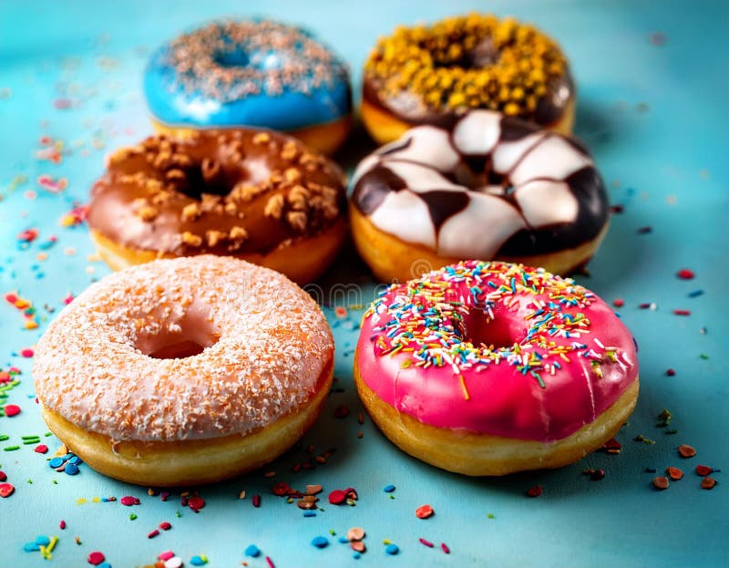 Colorful donuts. Assortiment of donuts with various colors and toppings. stock illustration
