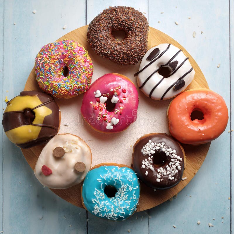 Colorful donuts. Assortiment of donuts with various colors and toppings. royalty free illustration