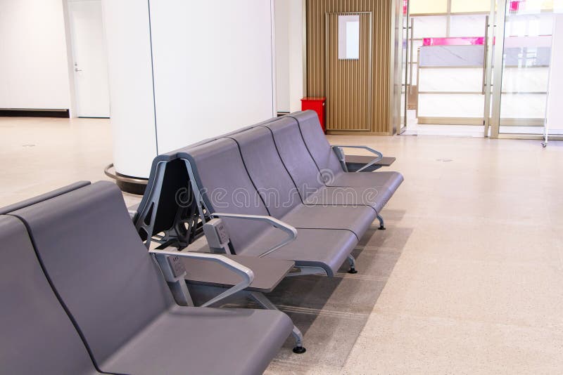 Empty Chairs brown for passengers waiting at airport lounge area station room. stock photography