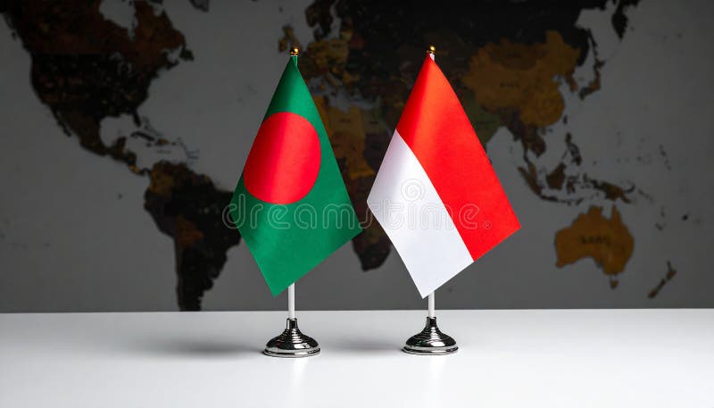 Crossed national flags of Indonesia and Bangladesh on a silver stand against a world map backdrop. The Indonesian flag features two horizontal bands of red over white. The Bangladeshi flag is dark green with a red circle slightly off-center. Both flags are positioned centrally, emphasizing international relations or diplomacy between the two countries. The world map is in shades of grey, adding geographical context. Indonesia and Bangladesh flags for official meeting against background of world map. Al Generated. World flag font illustrations