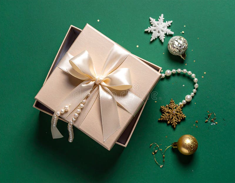 Christmas gift box with elegant pearl jewelry and decorations on a green background. royalty free illustration