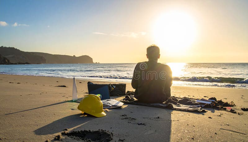 Someone relaxing on the beach with work surrounding them royalty free illustration