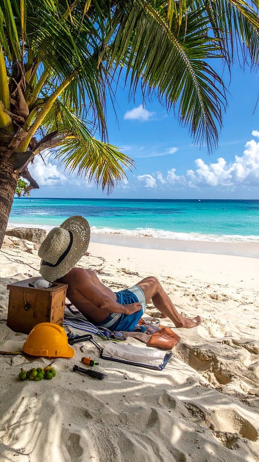 Someone relaxing on the beach with work surrounding them stock illustration