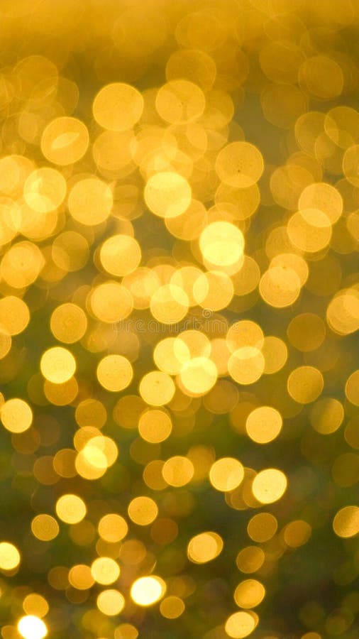 Abstract golden bokeh background with soft focus light effects for artistic designs stock photo