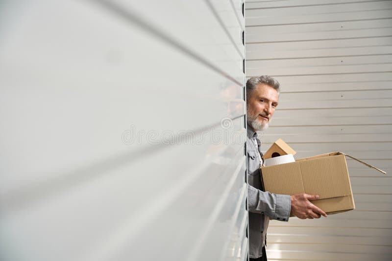 Male carry box, working in storage unit royalty free stock photo