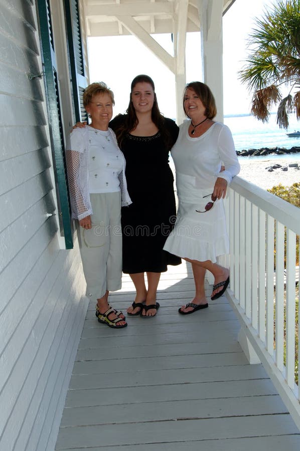 Three women of different generations on the porch of a beach house. Three women of different generations on the porch of a beach house