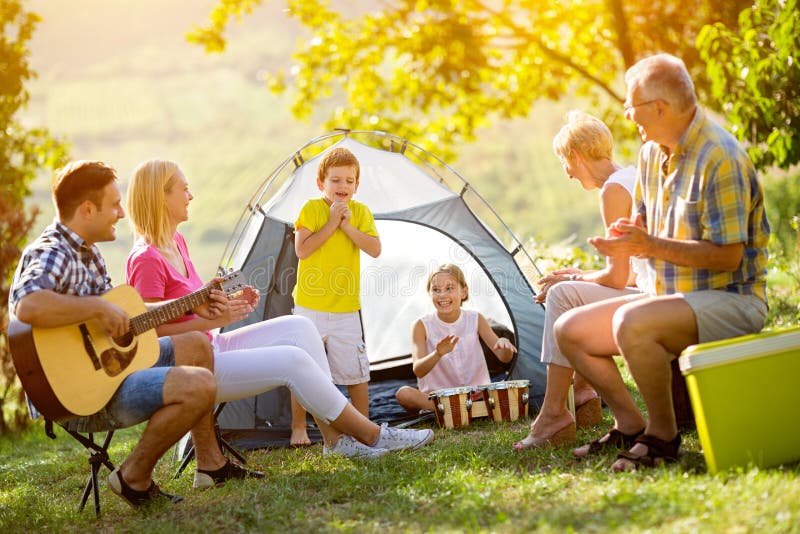 Generation family playing a guitar and singing stock photo Generation family playing a guitar and singing stock photo