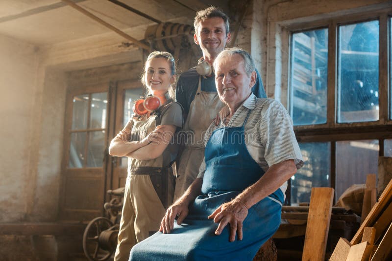 Generations of carpenters in their family business workshop