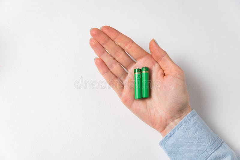 Generic AA Alkaline Batteries on Palm on White Background. Accumulator