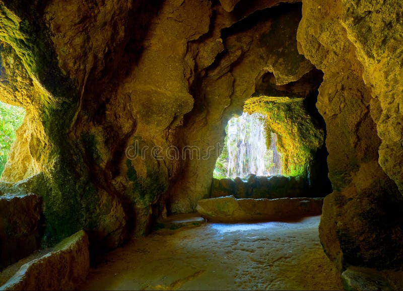 La Gruta & x28;grotto& x29; a artificial cave with a waterfall in Genoves Park, Botanical Garden of Cadiz. Andalusia, Spain, lake, atlantic, beautiful, beauty, bench, blue, city, cityscape, color, decoration, design, downtown, europe, european, evergreen, exterior, famous, place, field, flower, grass, landmark, landscape, light, mediterranean, nature, nobody, outdoor, outside, path, pedestrian, plant, sea, spanish, summer, sunlight, sunny, tourism, touristic, tourists, tree. La Gruta & x28;grotto& x29; a artificial cave with a waterfall in Genoves Park, Botanical Garden of Cadiz. Andalusia, Spain, lake, atlantic, beautiful, beauty, bench, blue, city, cityscape, color, decoration, design, downtown, europe, european, evergreen, exterior, famous, place, field, flower, grass, landmark, landscape, light, mediterranean, nature, nobody, outdoor, outside, path, pedestrian, plant, sea, spanish, summer, sunlight, sunny, tourism, touristic, tourists, tree