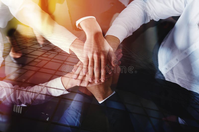 Business people joining hands in a circle in the office. concept of teamwork and partnership. double exposure. Business people joining hands in a circle in the office. concept of teamwork and partnership. double exposure