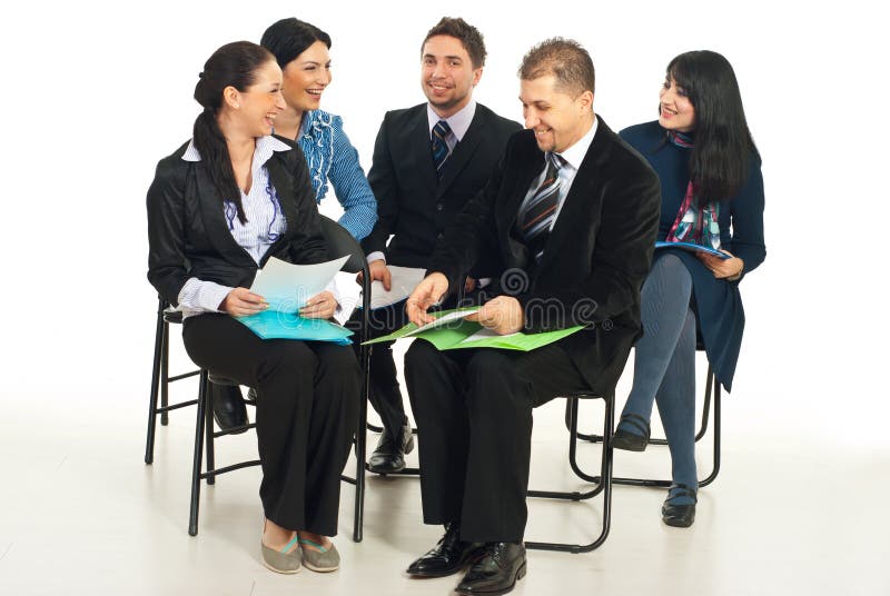 Five business people sitting on chairs at conference and laughing together. Five business people sitting on chairs at conference and laughing together