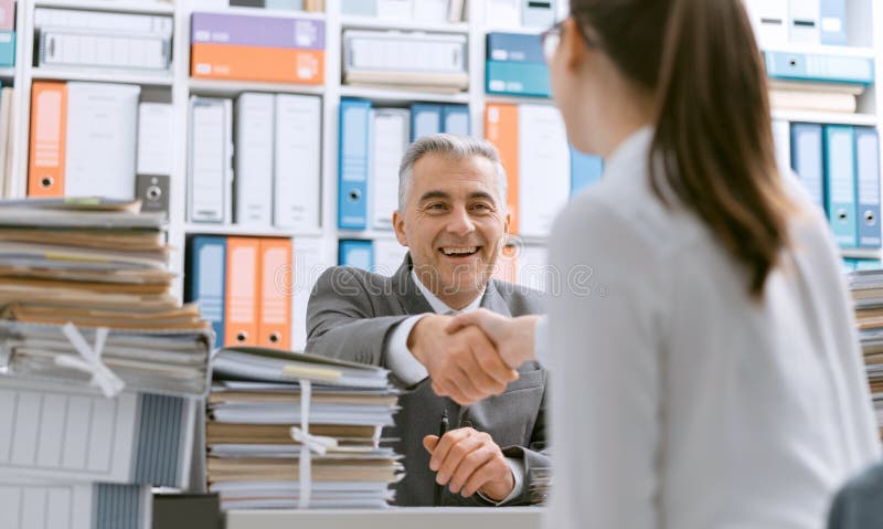 Gens d'affaires se serrant la main dans le bureau photo stock Gens d'affaires se serrant la main dans le bureau photo stock