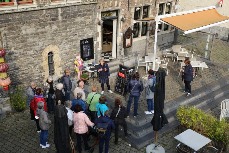 Gent, Belgium - October 9. 2021: View on crowd of people on guided tour through old town center