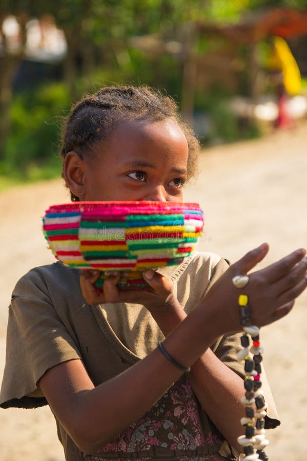 OMO, ETHIOPIA - SEPTEMBER 20, 2011: Unidentified Ethiopian beautiful girl tries to sell traditional beads. People in Ethiopia suffer of poverty due to the unstable situation. OMO, ETHIOPIA - SEPTEMBER 20, 2011: Unidentified Ethiopian beautiful girl tries to sell traditional beads. People in Ethiopia suffer of poverty due to the unstable situation