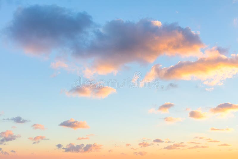 Gentle colors of sunrise sky with light clouds - background