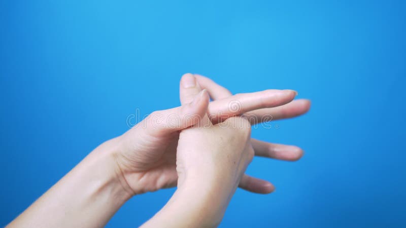 Gentle female hands with natural manicure move beautifully on a blue background. Place for text. royalty free stock photography Gentle female hands with natural manicure move beautifully on a blue background. Place for text. royalty free stock photography