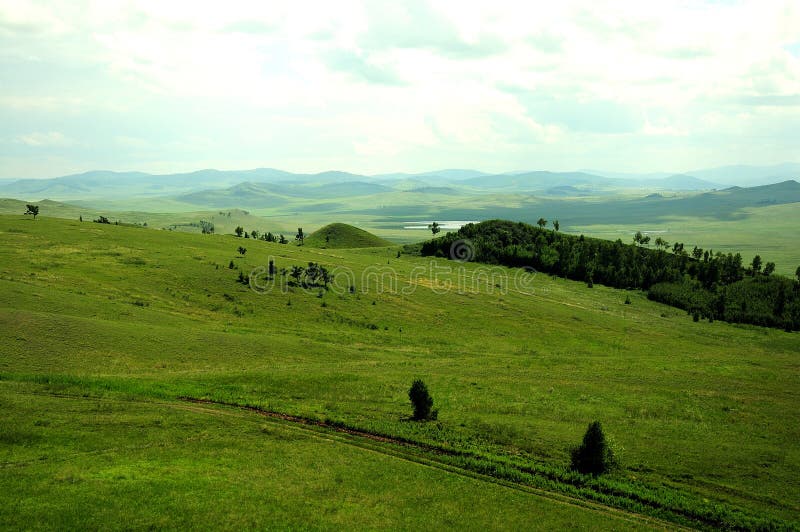 A Gentle Slope of a High Hill with Sheer Stone Cliffs at the Top and a ...