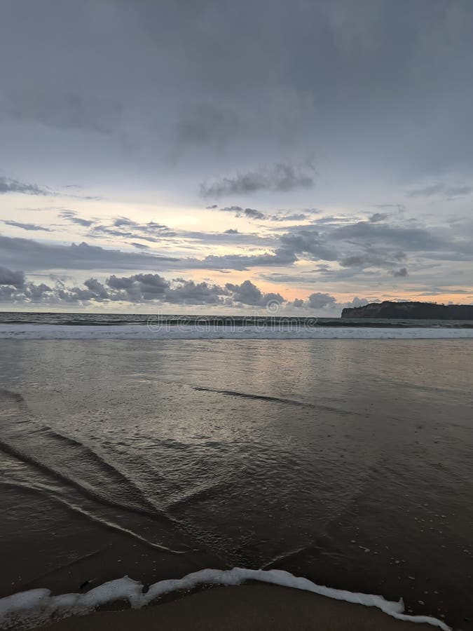 Gentle Waves Beneath Heavy Clouds Harboring Light royalty free stock image