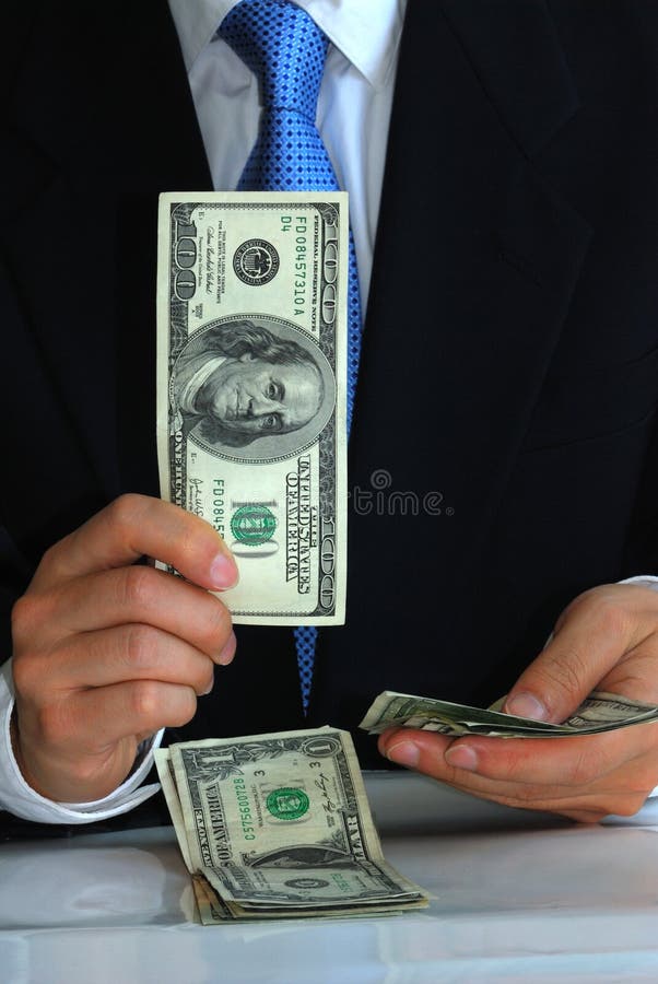 A gentleman holding the hundred dollar bill like flipping playing cards. A gentleman holding the hundred dollar bill like flipping playing cards