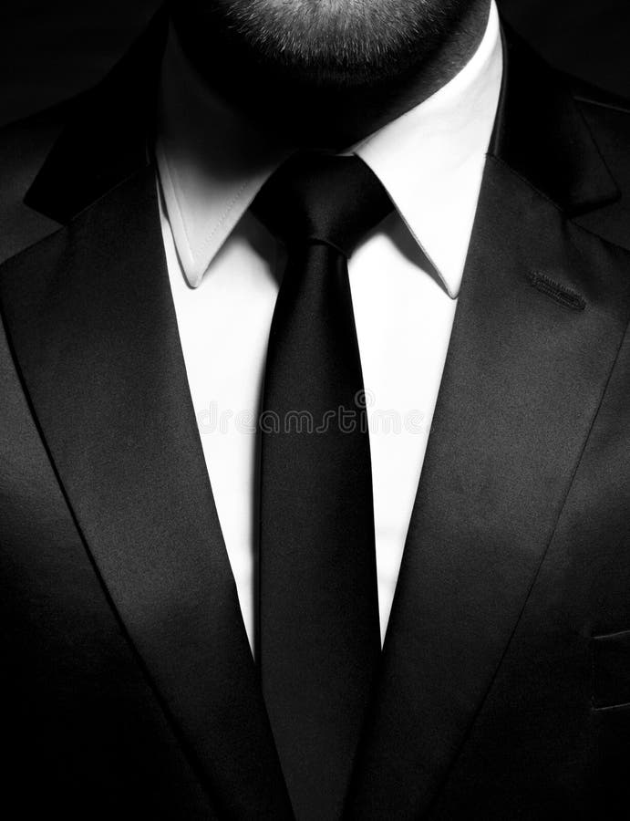 Gentleman wearing a black suit, shirt and tie, tuxedo