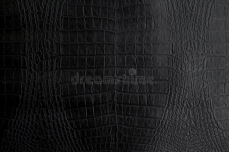Genuine black Crocodile leather background in dark tone beautiful stock photography Genuine black Crocodile leather background in dark tone beautiful stock photography