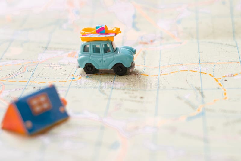 Geographical concept of travel and leisure. Toy old retro trailer stands near the hut. Selective focus. The blue car goes to the campground where the tent is