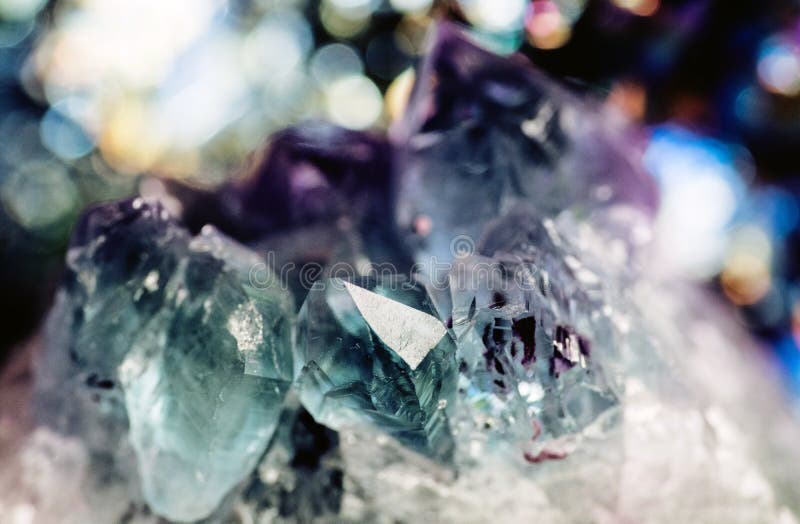 Geology of beauty. Natural cosmic wild jewels. Texture of gemstone lilac Fluorite closeup as a part of cluster geode filled with rock Quartz crystals. Geology of beauty. Natural cosmic wild jewels. Texture of gemstone lilac Fluorite closeup as a part of cluster geode filled with rock Quartz crystals.