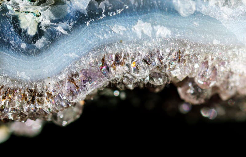 Geology of beauty. Natural wild jewels. Texture of gemstone lilac Amethyst closeup as a part of cluster geode filled with rock Quartz crystals. Geology of beauty. Natural wild jewels. Texture of gemstone lilac Amethyst closeup as a part of cluster geode filled with rock Quartz crystals.