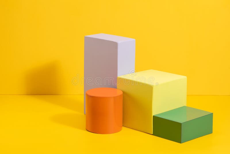 Geometric shapes in different colors on yellow background. royalty free stock image