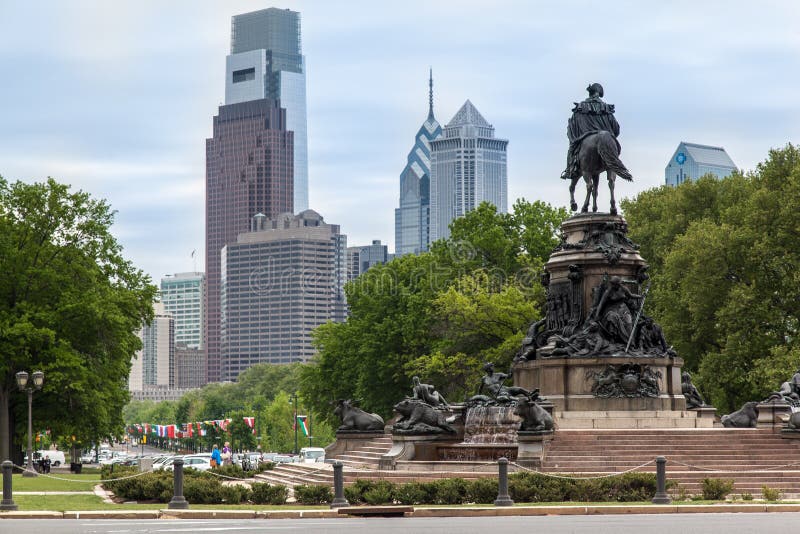 The George Washington monument and in Eakins Oval and the modern glass windows building towers of downtown. Philadelphia, Pennsylvania, United States. The George Washington monument and in Eakins Oval and the modern glass windows building towers of downtown. Philadelphia, Pennsylvania, United States.