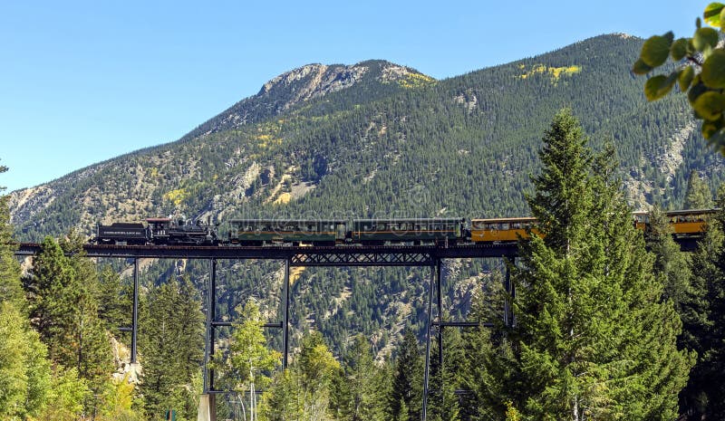 GEORGETOWN,COLORADO,UNITED STATES- SEPTEMBER 22,2019: Historic Steam Train with passengers cross the bridge in the Colorado mountains and commits Georgetown Loop. GEORGETOWN,COLORADO,UNITED STATES- SEPTEMBER 22,2019: Historic Steam Train with passengers cross the bridge in the Colorado mountains and commits Georgetown Loop