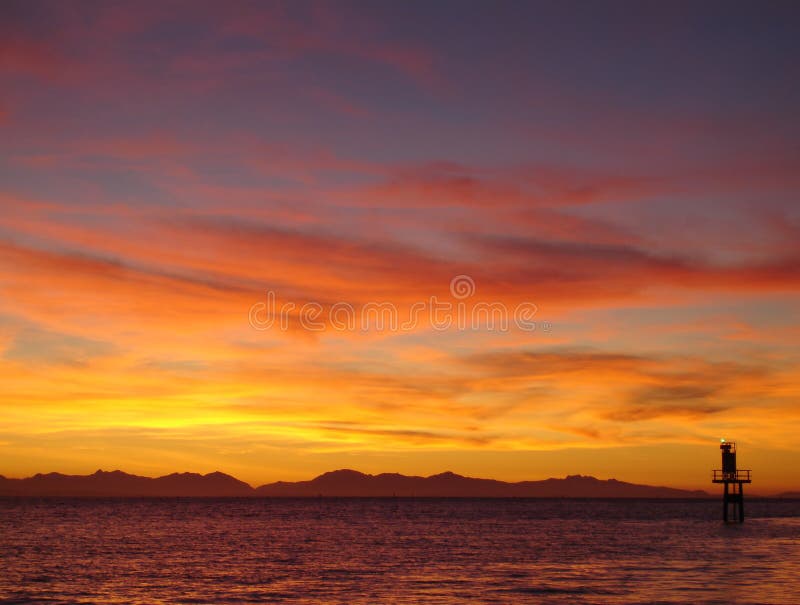 Sunset at the mouth of the Fraser River looking across Georgia Strait at the Gulf Islands and Vancouver Island in the distance. British Columbia, Canada. Sunset at the mouth of the Fraser River looking across Georgia Strait at the Gulf Islands and Vancouver Island in the distance. British Columbia, Canada.