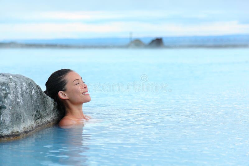 Geothermal spa - woman relaxing in hot spring pool