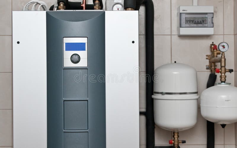 Modern geothermal furnace unit at home setting. Renewable energy for homes concept. Heat pump equipment for a private house. Modern geothermal furnace unit at home setting. Renewable energy for homes concept. Heat pump equipment for a private house