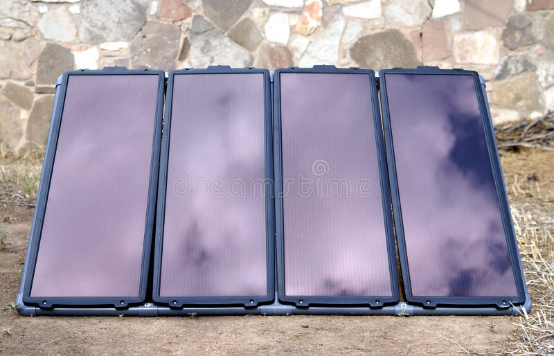 Solar Generator. Backyard home solar panel generator array with sky and cloud reflections. Solar Generator. Backyard home solar panel generator array with sky and cloud reflections
