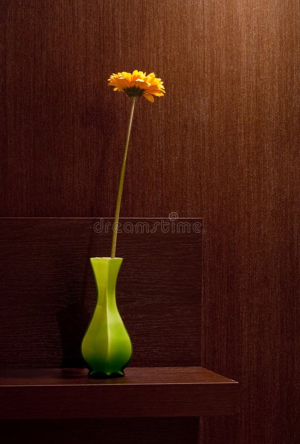 Gerbera in vase at brown home background