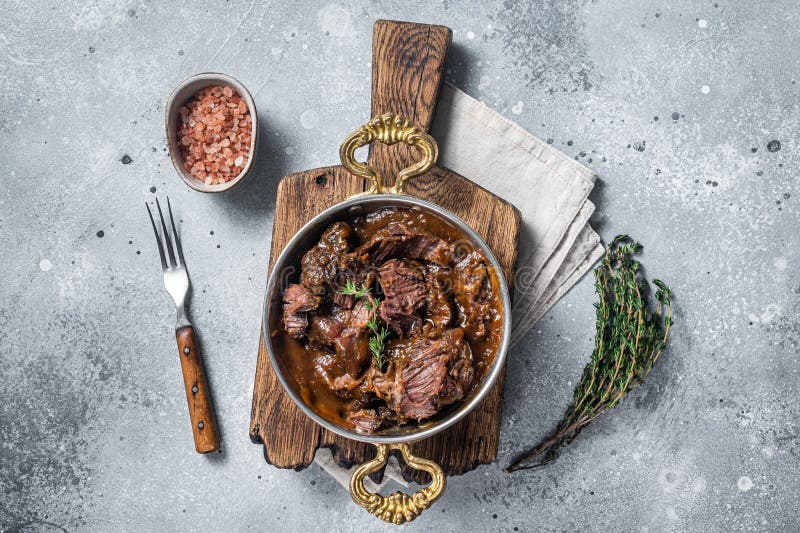 German Braised Beef Cheeks in Brown Red Wine Sauce. Gray Background