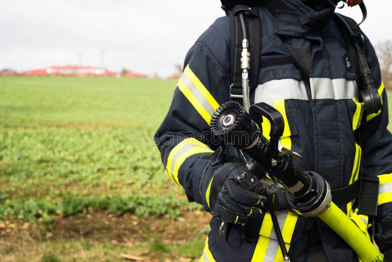 German Firefighter with Water Hose in Action Stock Image Image of