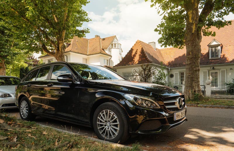 German houses and Mercedes-Benz luxury wagon car perked on german street stock image German houses and Mercedes-Benz luxury wagon car perked on german street stock image