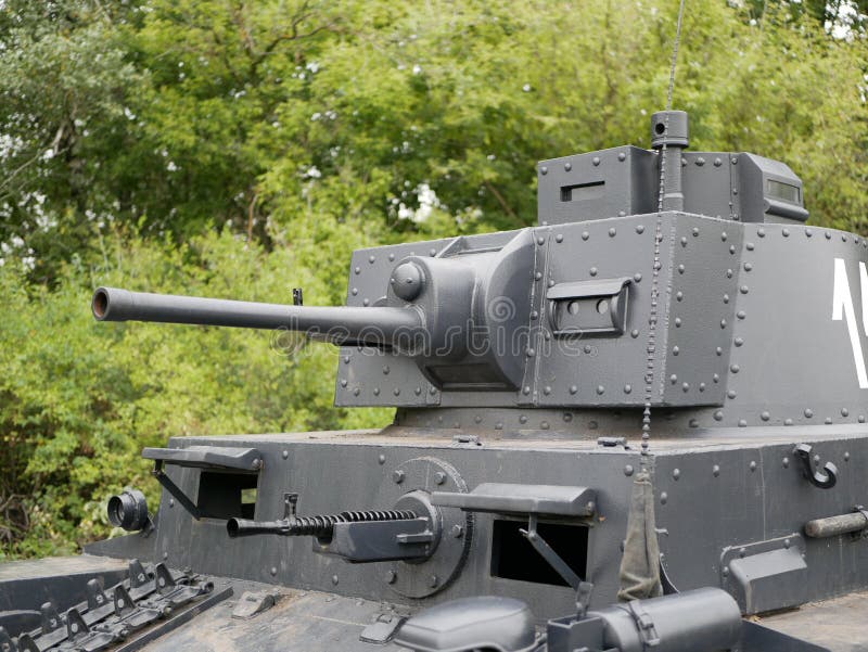 German medium tank of the Second World war in working order. the tank is painted black against a background of green trees in summ