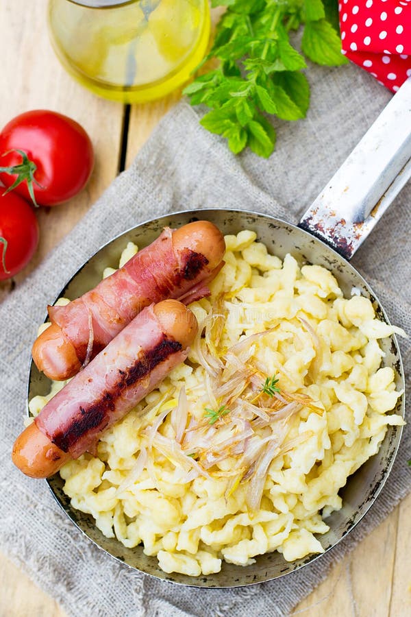 German Noodles Spatzle with Fried Onions and Sausages Stock Photo