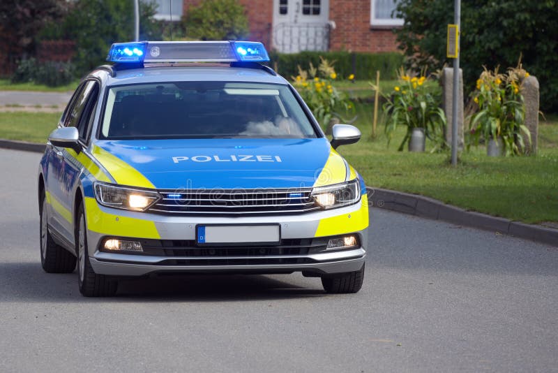 German Police Car on Duty Driving with Flashing Blue Lights on through ...
