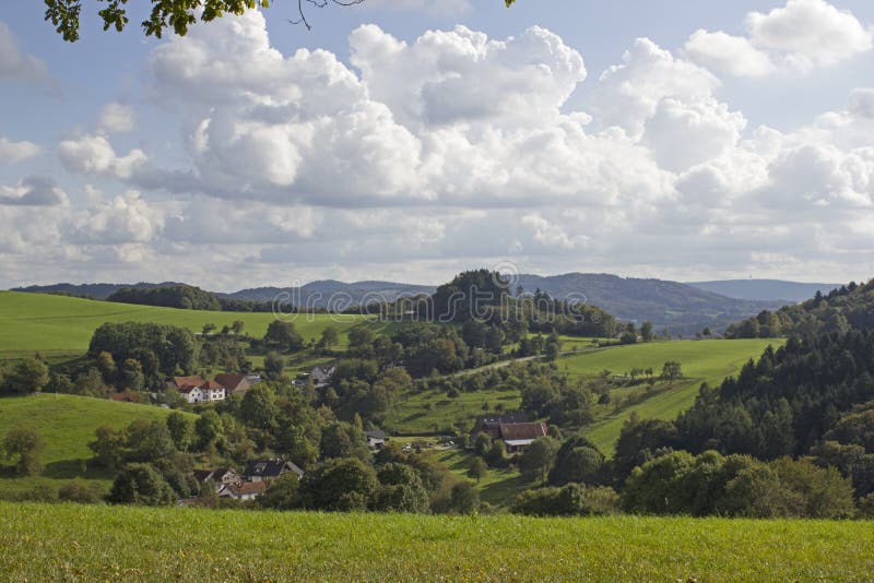 German Rural Scenery of Timber Barns in Sunny Meadow in Spring Stock