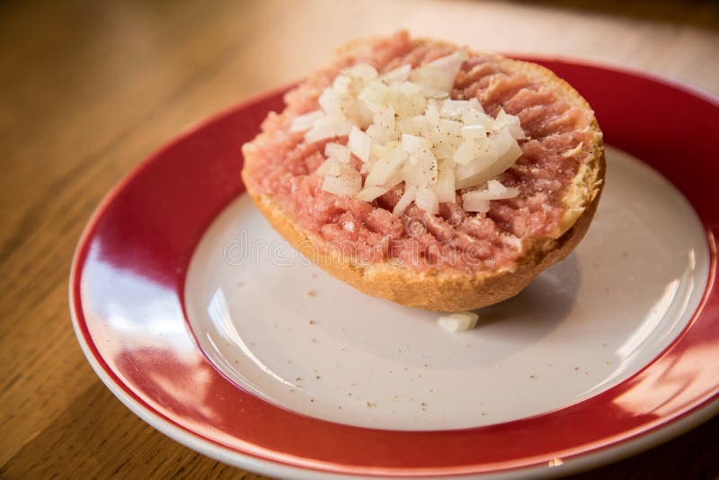 German Snack Buns with Raw Minced Beef Tatar Meat, Pepper and Onions on Bread Bun Roll Stock